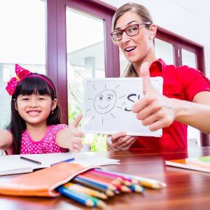 Young asian girl and private teacher smiling